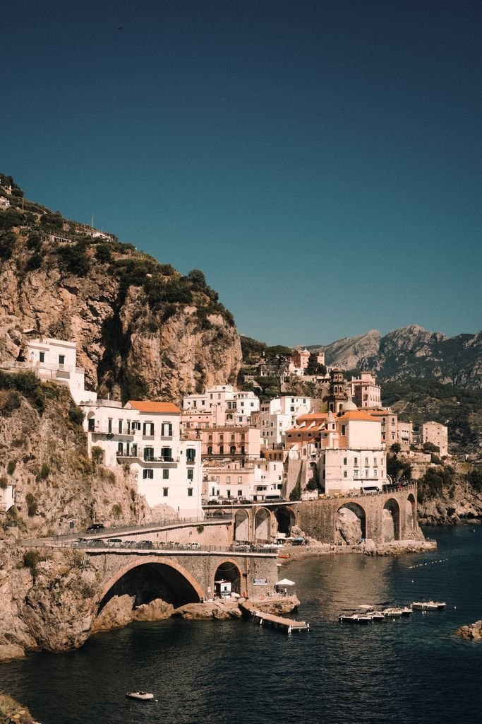 Captivating aerial view of Amalfi's picturesque town perched on rugged cliffs by the sea.